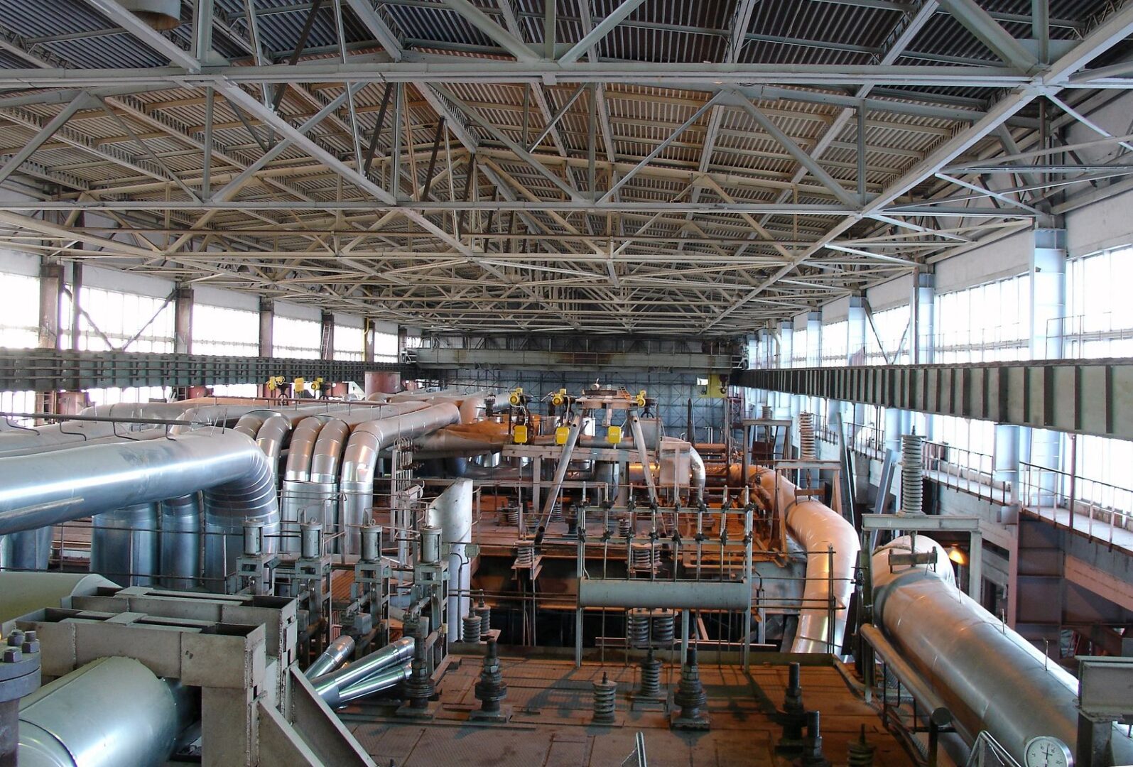 Industrial warehouse interior with piping and steel beams